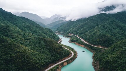 Fototapeta premium Serene Aerial View of Curving River Amidst Lush Green Mountains
