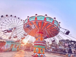 Vibrant Amusement Park Ride at Sunset