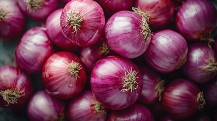 Vibrant assortment of fresh red onions stacked together showcasing their rich colors and textures in a detailed composition
