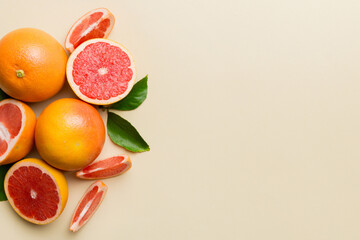 fresh Fruit grapefruit with Juicy grapefruit slices on colored background. Top view. Copy Space. creative summer concept. Half of citrus in minimal flat lay with copy space