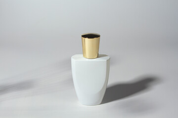Empty white perfume bottle on white background