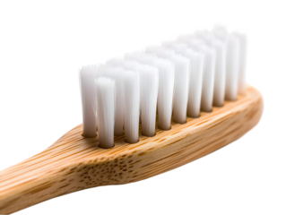 Eco-friendly bamboo toothbrush with soft bristles on a light background, representing sustainable oral care.