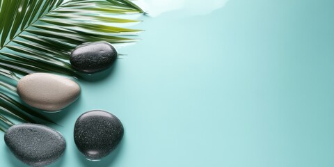 Relaxing spa stones alongside tropical leaves in serene water