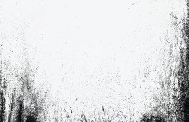 Abstract black dust and grunge texture on a white surface, creating a distressed vintage effect.