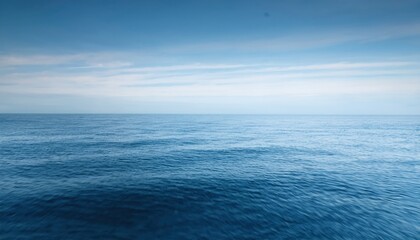 Obraz premium Tranquil seascape with soft ocean waters blending seamlessly into the horizon, creating a peaceful and meditative atmosphere with gentle waves and a calming color palette.