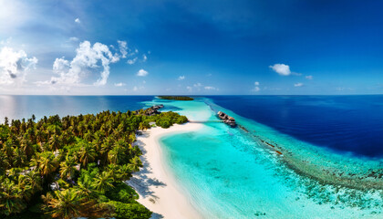 Tropical Paradise: An expansive aerial view captures the beauty of a tropical island, boasting crystal-clear turquoise waters, pristine white sand beaches, and lush green palm trees under a bright.