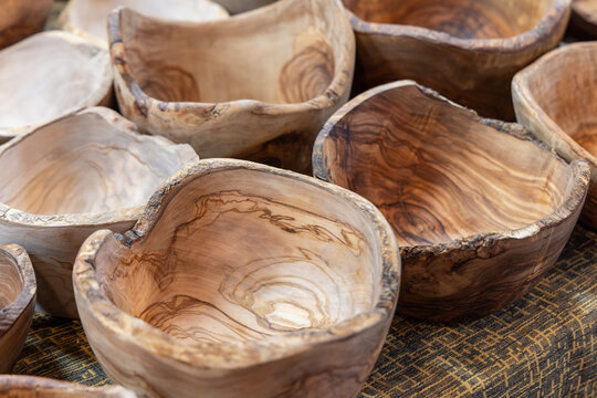 Handcrafted wooden bowls with natural grain patterns and irregular edges are displayed together made from solid wood