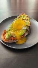 Healthy sandwich with avocado and poached eggs. Healthy food and diet concept.