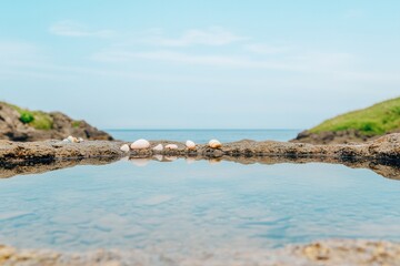 Fototapeta premium Tranquil coastal scene with clear water reflecting blue sky and