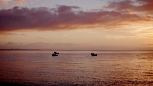 Boats moored out at Sea morning sun stock footage