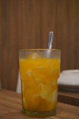 Refreshing orange coconut ice drink in a clear glass