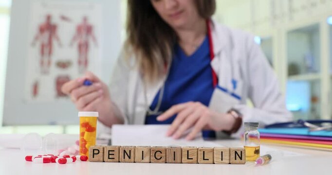 A healthcare professional in a medical setting is expertly writing a prescription for penicillin as required