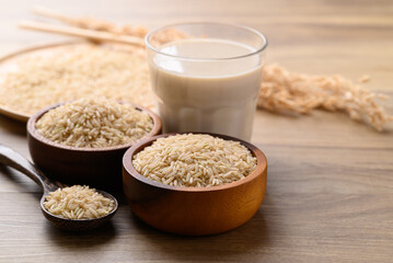 Organic rice milk in cup glass on wooden background, Alternative milk made from plant