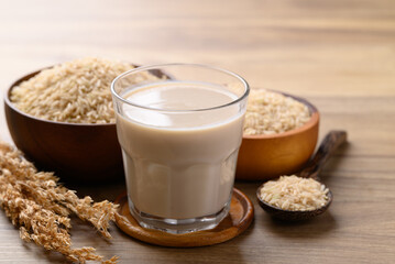 Organic rice milk in cup glass on wooden background, Alternative milk made from plant