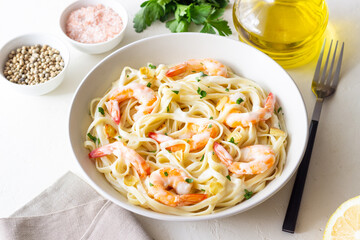 Linguine pasta in creamy garlic sauce with shrimps. Italian food.