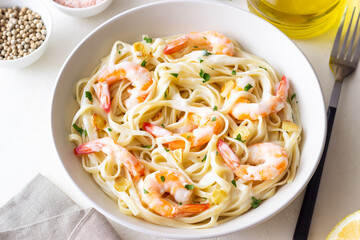 Linguine pasta in creamy garlic sauce with shrimps. Italian food.