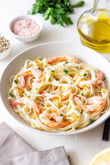 Linguine pasta in creamy garlic sauce with shrimps. Italian food.