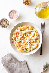 Linguine pasta in creamy garlic sauce with shrimps. Italian food.
