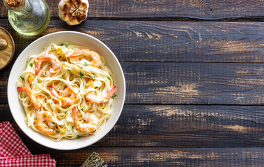 Linguine pasta in creamy garlic sauce with shrimps. Italian food.