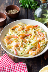 Linguine pasta in creamy garlic sauce with shrimps. Italian food.