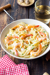 Linguine pasta in creamy garlic sauce with shrimps. Italian food.