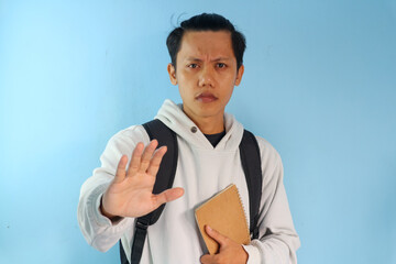 Asian male student college doing stop gesture with hand
