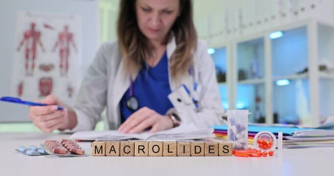 A dedicated healthcare worker analyzes macrolides, surrounded by medical references and detailed notes