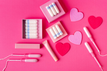 Many menstrual hygiene tampons from above on pink background in beautiful composition. Soft cotton absorbent menstrual tampons for women during menstruation. Feminine hygiene. 