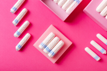 Many menstrual hygiene tampons from above on pink background in beautiful composition. Soft cotton...