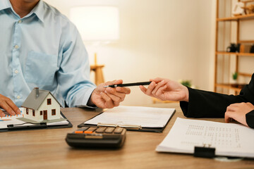 Fototapeta premium Businesswoman embraces client after successful property negotiation.