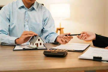 Fototapeta premium Businesswoman embraces client after successful property negotiation.