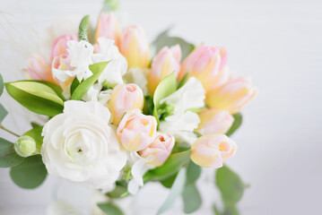 Women's Day greeting card. delicate bouquet featuring white, pink, ranunculus flowers, accented with lush greenery, creating a soft and romantic floral arrangement.