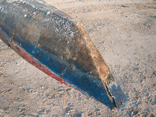 Wrecked fishing boat washed ashore by waves