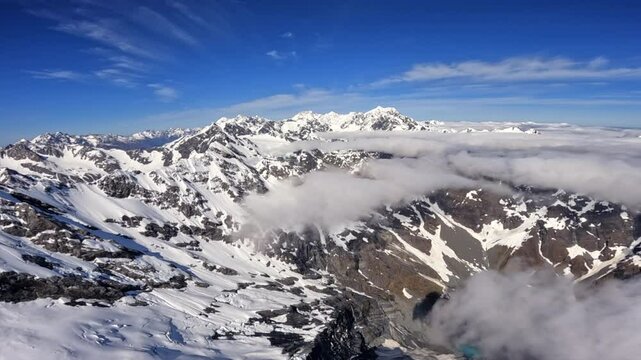 Flying over the breathtaking southern Alps above the clouds, New Zealand