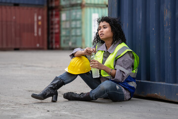 Container industry person sitting at warehouse cargo container ship tired of overworked. Female...