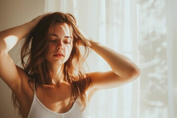 Soft morning light illuminates serene woman lost in thought with