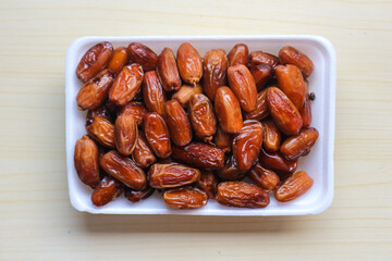 Kurma Tunisia or Tunisia dates, sweet dried dates palm fruits. on wooden table