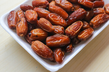Kurma Tunisia or Tunisia dates, sweet dried dates palm fruits. on wooden table