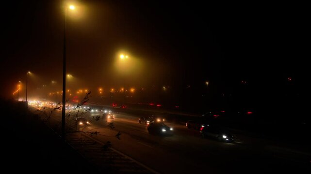 Misty traffic, cars at night of freeway, highway with mist and halation