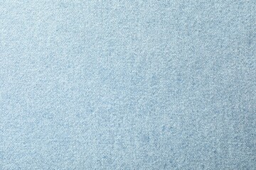 Texture of light blue jeans as background, closeup