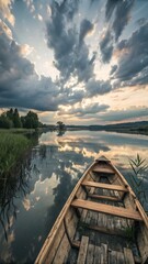 Gorgeous view of a tiny lake with stunning clouds in the sky and a wooden rowboat in focus