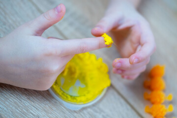 child, girl molds shaping foam clay and stretching slime. Hands-on creative fun and sensory development for children, fine motor skills Development, Learning Through Play