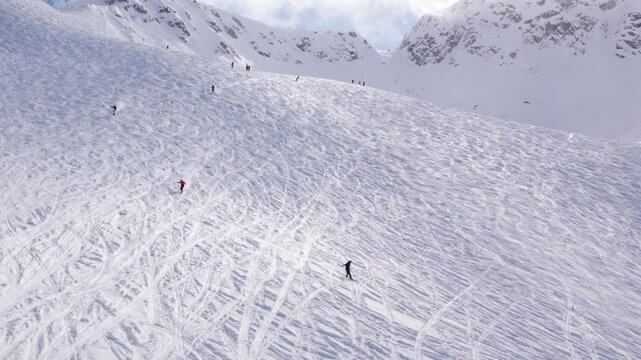 Snowboarders with breathtaking mountain vista, aerial footage, ski mountain, sunny day, winter, ski hill, Whistler BC. 5.4K 24FPS