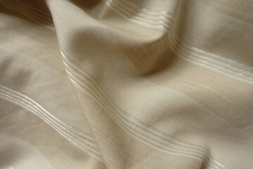 Draped light beige striped cotton and polyester fabric