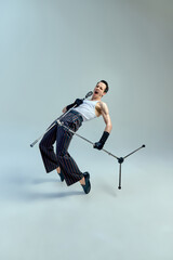 Rock-inspired energy. Stylish singer leaning back into performance with raw passion and dramatic...