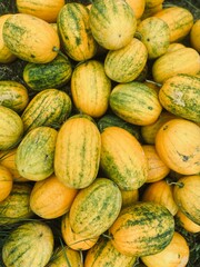 freshly harvested golden watermelons with vibrant yellow and green hues