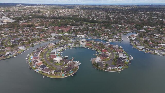 Breathtaking aerial orbit of James Cook Island&rsquo;s luxury waterfront homes in Sylvania Waters, Sydney, NSW, showcasing beautiful residential properties and serene coastal surroundings.