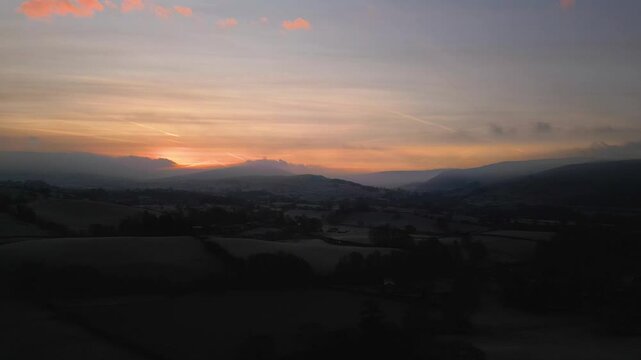 Stunning Drone footage of sunrise in the Yorkshire Dales above the village of Sedbergh. Dawn sunrise above the hills and misty landscape of the Yorkshire dales national Park.