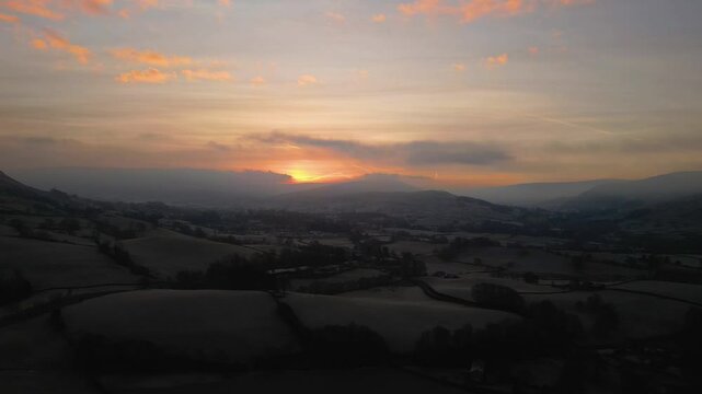 Stunning Drone footage of sunrise in the Yorkshire Dales above the village of Sedbergh. Dawn sunrise above the hills and misty landscape of the Yorkshire dales national Park.