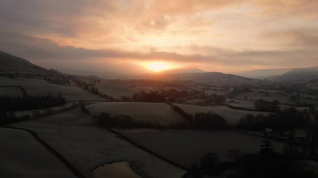 Stunning Drone footage of sunrise in the Yorkshire Dales above the village of Sedbergh. Dawn sunrise above the hills and misty landscape of the Yorkshire dales national Park.